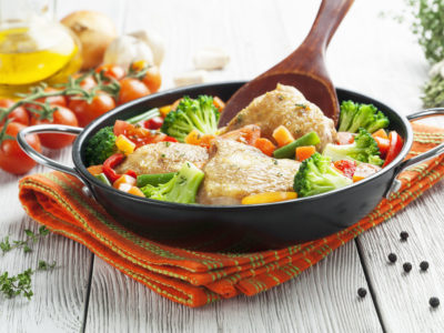 Fried chicken with vegetables in the  pan